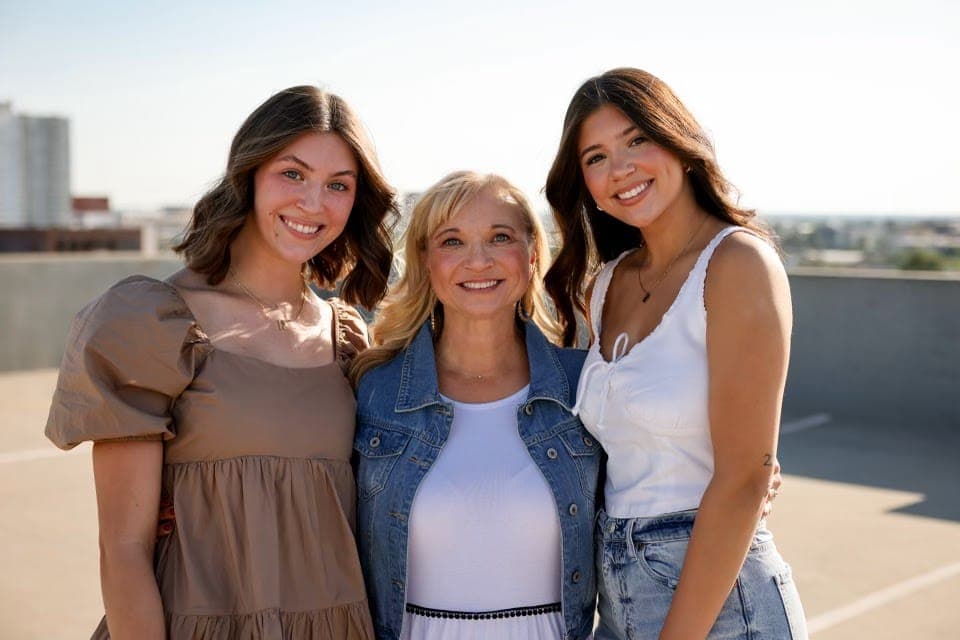 Terry's daughters and Robin on a rooftop
