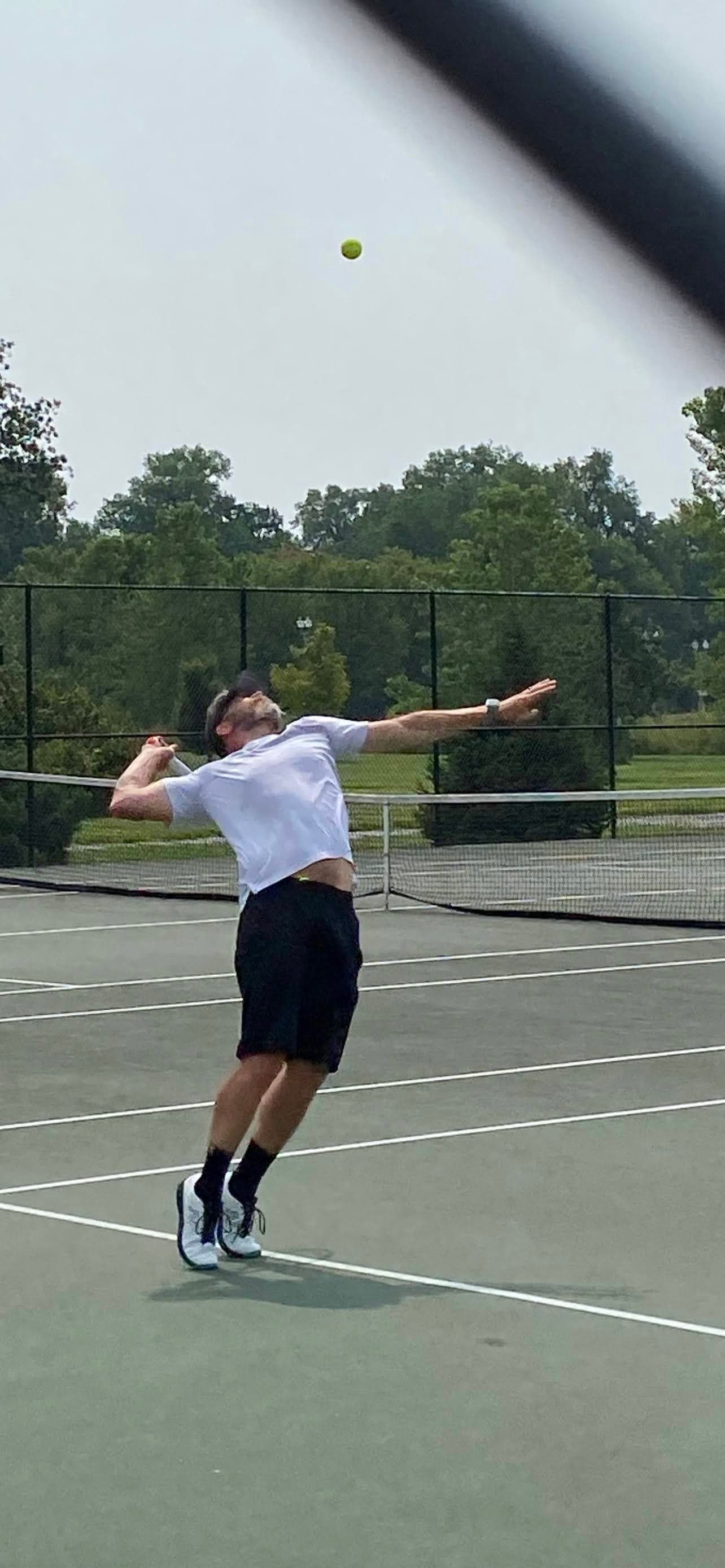 Terry serving on a tennis court