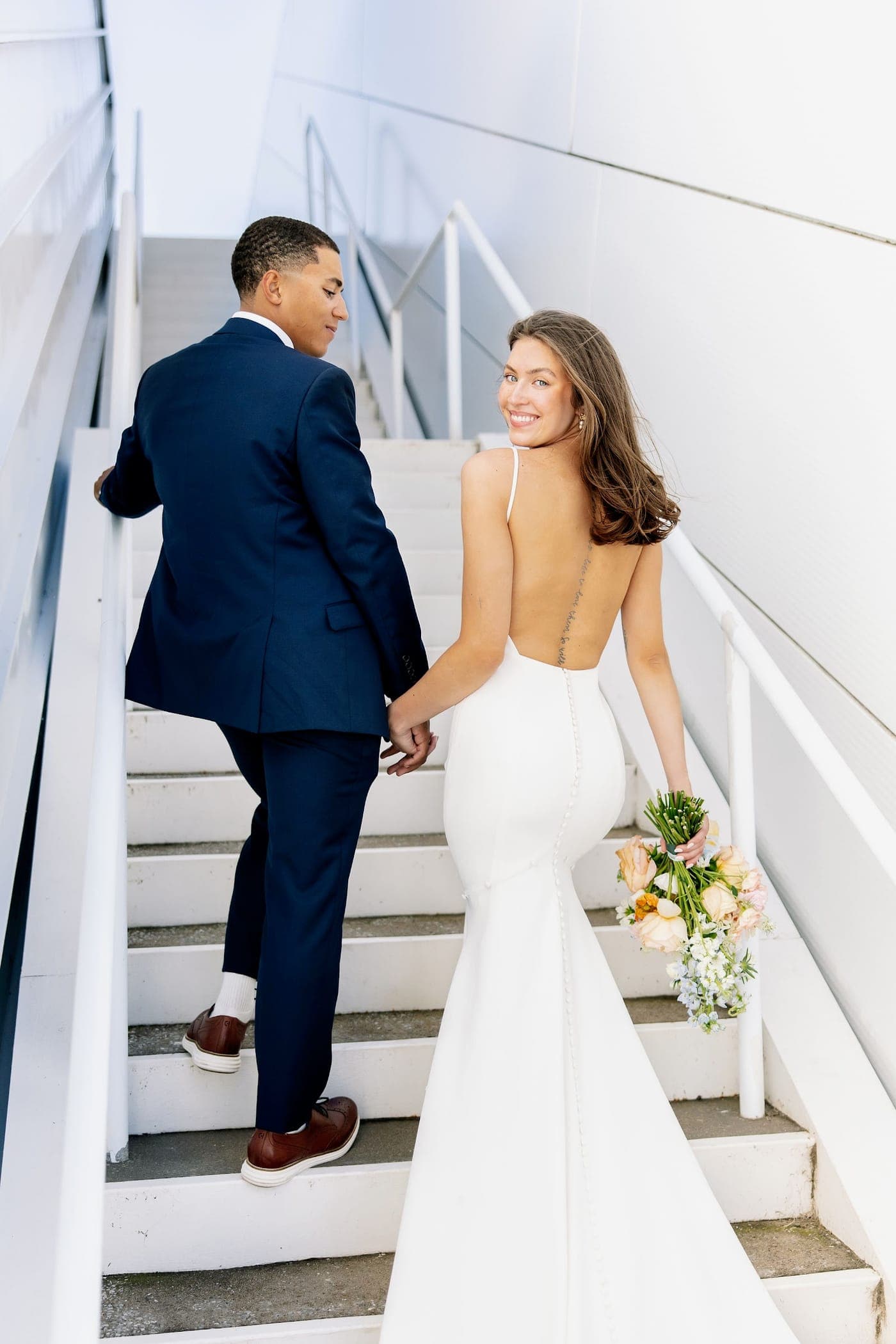 Riley and Reia just married, on the stairs